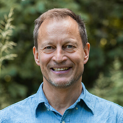 Mitarbeiterfoto vor grünem Hintergrund